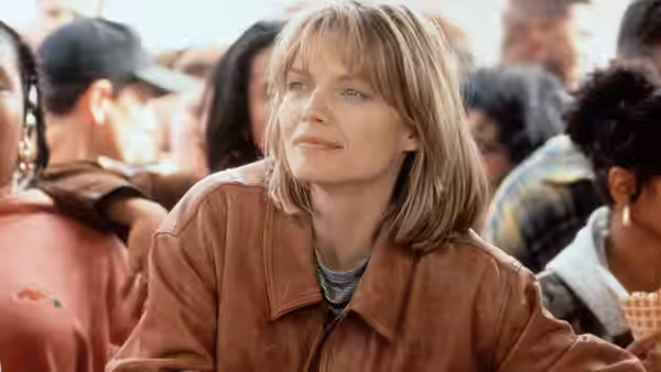 Louanne Johnson (Michelle Pfeiffer) sits among students in a crowded cafeteria