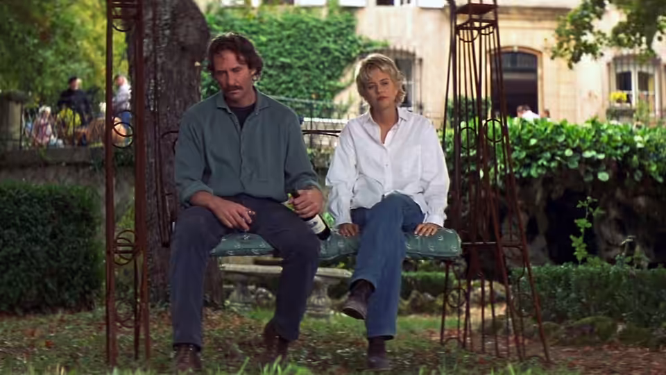 Luc Teyssier (Kevin Kline) and Kate (Meg Ryan) sit together on a garden bench