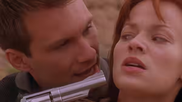 Vic Deakins (John Travolta) holds Terry Carmichael (Samantha Mathis) at gunpoint