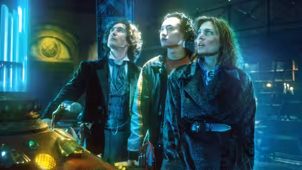 Chang Lee, the Doctor (Paul McGann), and Dr. Grace Holloway stand together inside the TARDIS