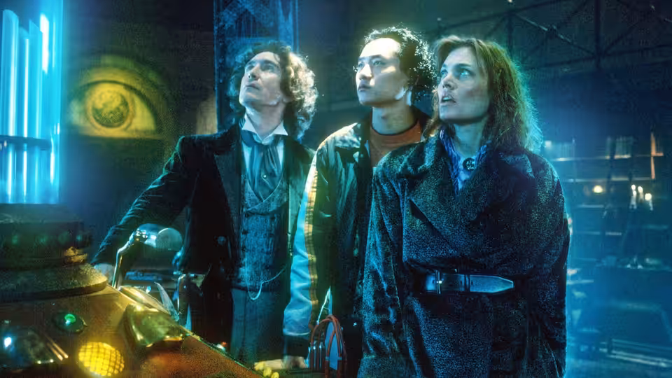Chang Lee, the Doctor (Paul McGann), and Dr. Grace Holloway stand together inside the TARDIS