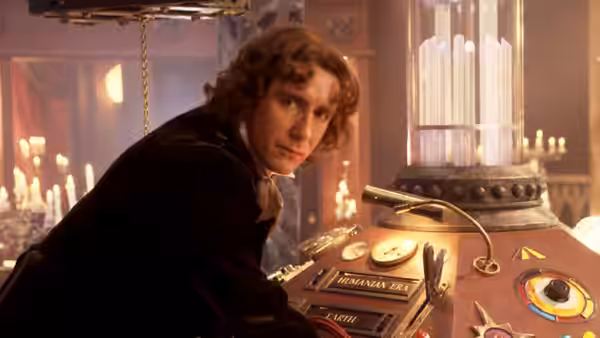 The Doctor (Paul McGann) leans over the TARDIS console