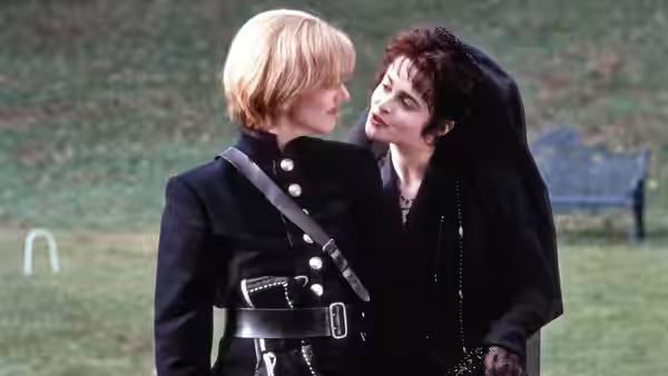 Olivia (Helena Bonham Carter) leans toward Viola (Imogen Stubbs) in a garden