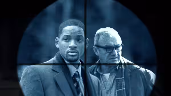 Robert Clayton Dean (Will Smith) and Brill (Gene Hackman) appear through a surveillance scope