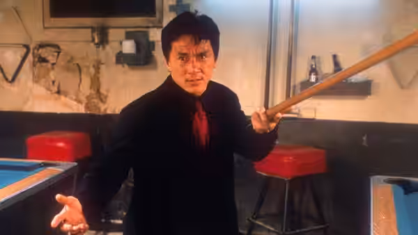 Lee (Jackie Chan) grips a pool cue in a bar