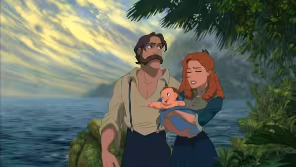 Tarzan and Jane hold their baby beside the ocean, framed by jungle foliage