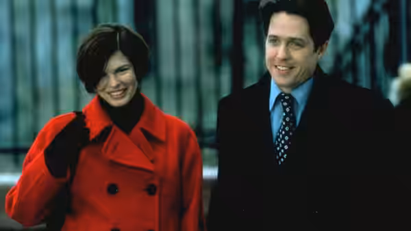Gina Vitale (Jeanne Tripplehorn) and Michael Felgate (Hugh Grant) walk together along a city street