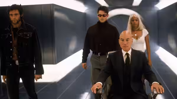 Logan, Cyclops, Storm and Xavier move through a corridor at the X-Mansion