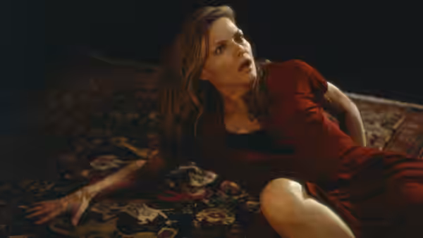 Claire Spencer (Michelle Pfeiffer) lies startled on a patterned rug