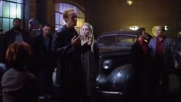 Memphis Raines (Nicolas Cage) addresses the crew beside a vintage car, with Sway nearby