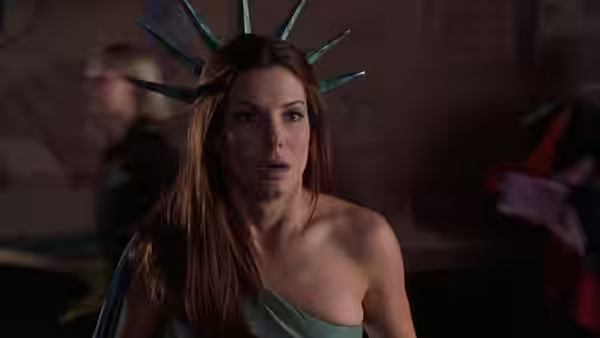Gracie Hart (Sandra Bullock) wears a Statue of Liberty crown and stares ahead