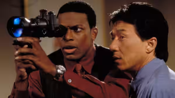 Carter aims a night-vision scope while Lee looks on