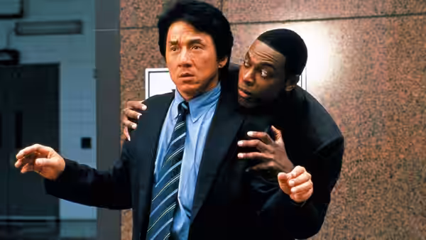 Lee and Carter stand together outside a brick building