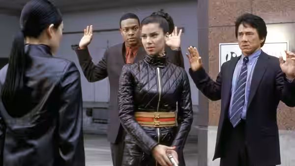 Carter and Lee raise their hands as a woman faces them