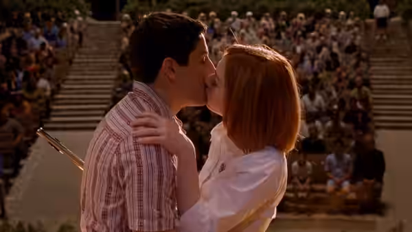 Jim Levenstein and Michelle Flaherty kiss in front of a seated audience