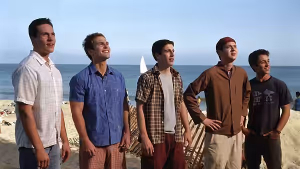 Kevin Myers, Chris Ostreicher, Jim Levenstein, Steve Stifler and Paul Finch stand together on a beach