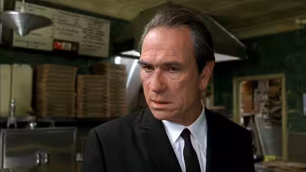 Kay (Tommy Lee Jones) stands inside a restaurant kitchen