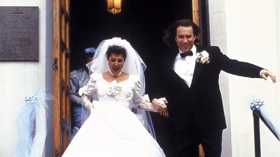 Toula Portokalos (Nia Vardalos) and Ian Miller (John Corbett) emerge from the church as newlyweds