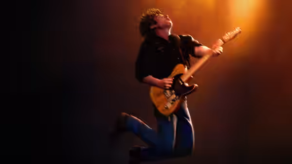Jeremy Allen White as Bruce Springsteen jumps while playing electric guitar onstage
