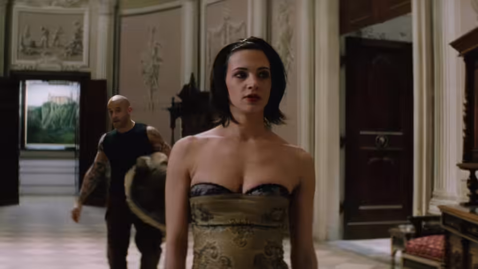 Yelena (Asia Argento) stands in an ornate hall as Xander Cage (Vin Diesel) walks behind her