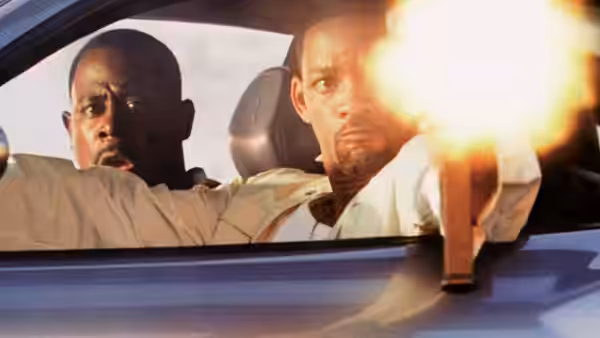 Mike Lowrey (Will Smith) fires a pistol from a car as Marcus Burnett (Martin Lawrence) drives