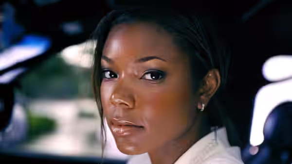Syd (Gabrielle Union) looks back from the passenger seat of a car