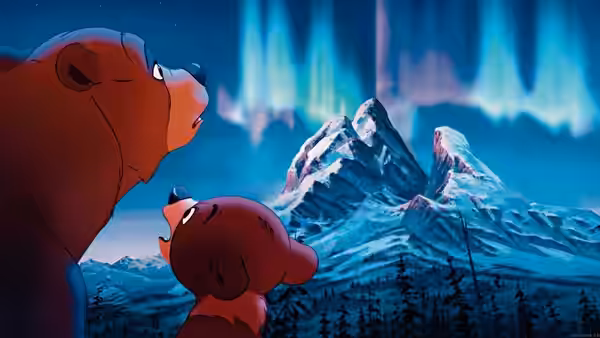 Kenai (Joaquin Phoenix) and Koda (Jeremy Suarez) gaze at the northern lights above snowy mountains