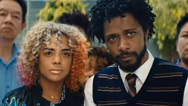 Tessa Thompson and LaKeith Stanfield stand among a crowd outdoors