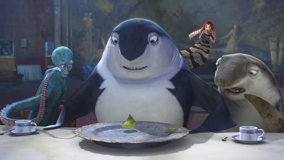 Don Lino sits at a dining table with several fish gathered around him
