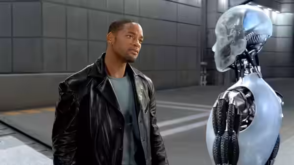 Del Spooner (Will Smith) faces a humanoid robot in a tiled industrial facility