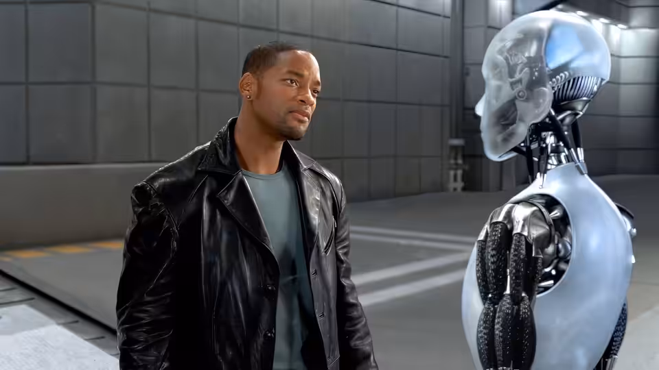 Del Spooner (Will Smith) faces a humanoid robot in a tiled industrial facility