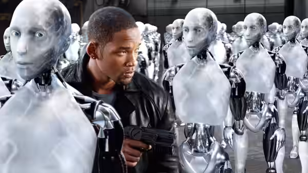Del Spooner (Will Smith) moves cautiously among rows of humanoid robots, holding a gun