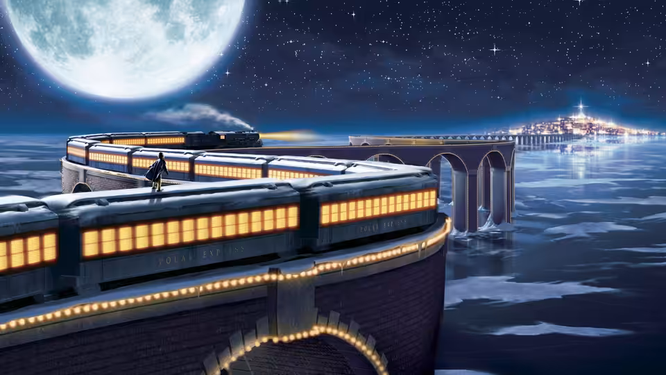 A passenger train curves across a bridge beneath the moon