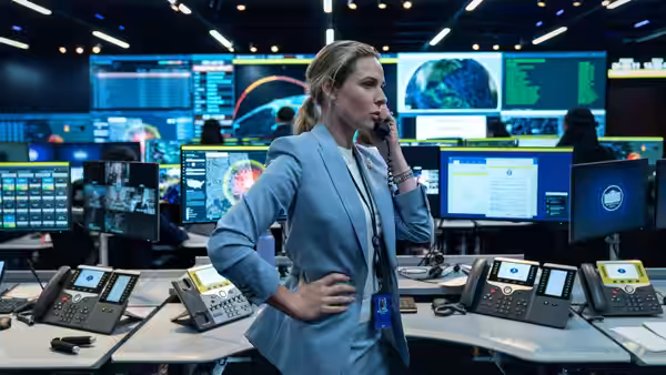 Captain Olivia Walker (Rebecca Ferguson) on the phone in a command center