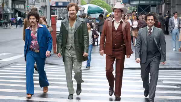 Brian Fantana, Ron Burgundy, Champ Kind, and Brick Tamland walk across a city crosswalk