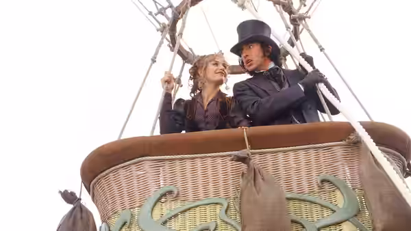 Monique La Roche (Cécile de France) and Phileas Fogg (Steve Coogan) stand together in a balloon basket
