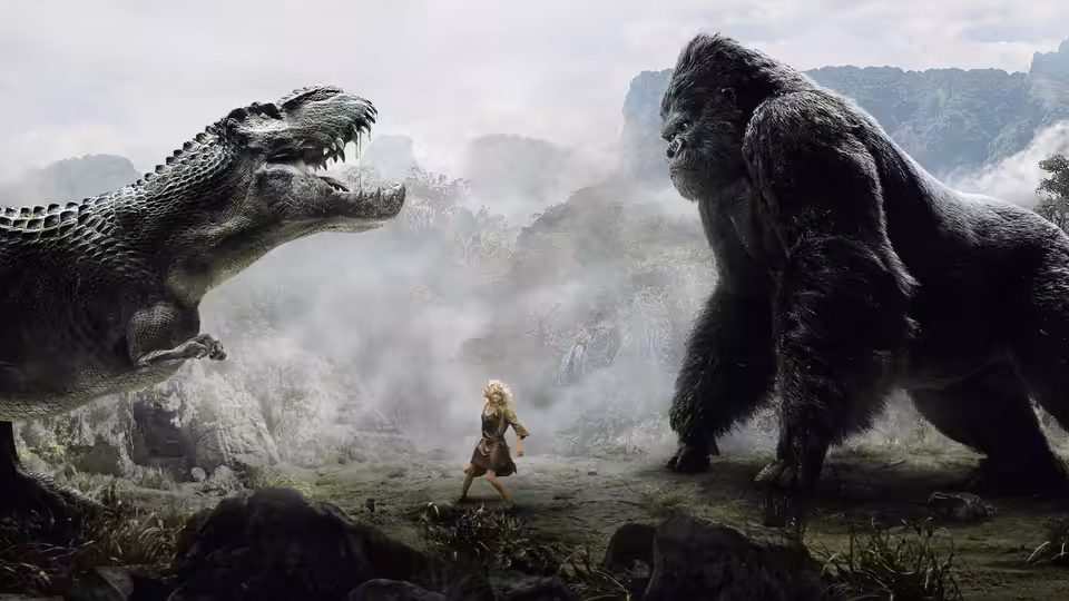 Ann Darrow stands between Kong and a roaring dinosaur in a misty jungle clearing