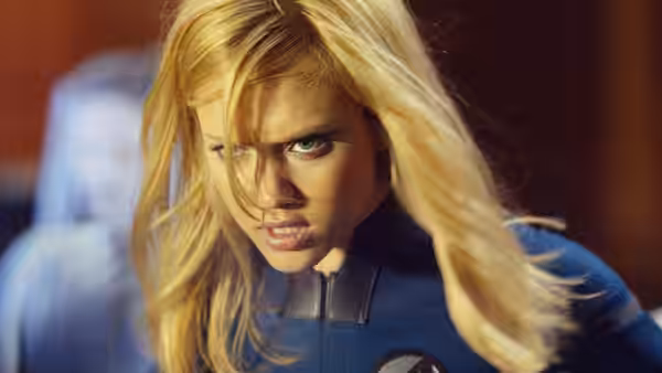 Sue Storm (Jessica Alba) leans forward tensely in her blue Fantastic Four suit