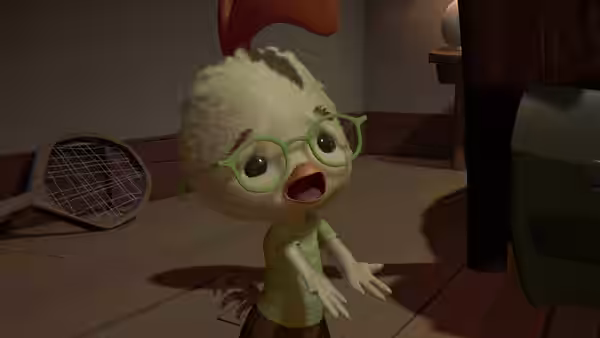 A small fluffy, bespectacled creature reaches forward beside a tennis racket
