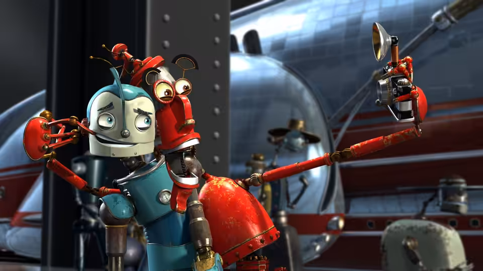 Rodney Copperbottom (Ewan McGregor) stands beside a red robot in a city workshop