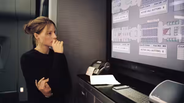 Kyle (Jodie Foster) studies an aircraft seating diagram in the control room