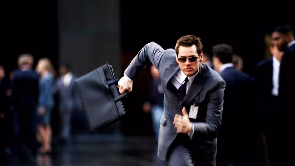Dick Harper (Jim Carrey) sprints through a business district carrying a briefcase