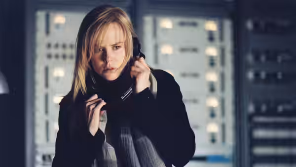 Silvia Broome (Nicole Kidman) holds a telephone receiver in a control room