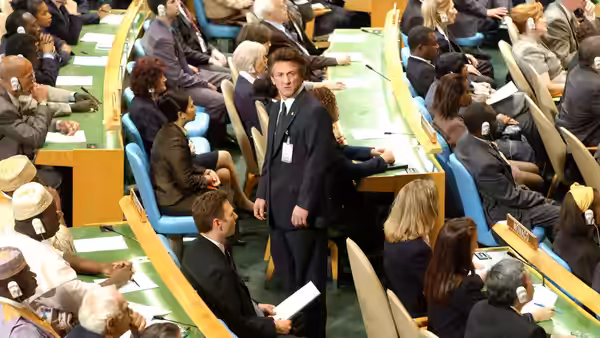 Tobin Keller (Sean Penn) stands among delegates seated in the United Nations assembly hall