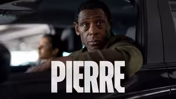 Pierre (David Harewood) sits in a car, turning to look behind him