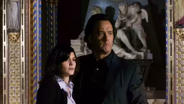 Robert Langdon (Tom Hanks) and Sophie Neveu (Audrey Tautou) stand inside an ornate church