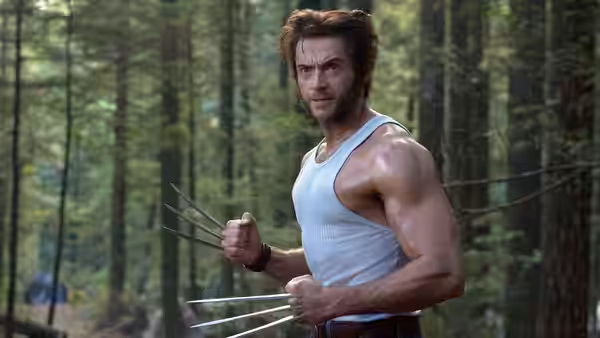 Wolverine (Hugh Jackman) raises his claws among the trees