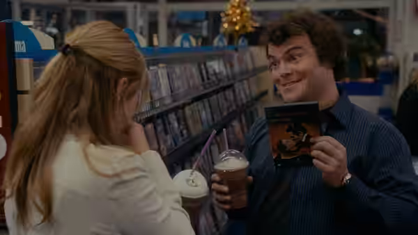 Miles (Jack Black) shows Iris (Kate Winslet) a DVD in a video store