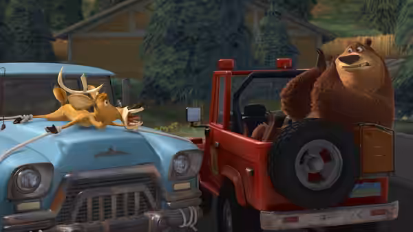 Boog rides in the back of a red pickup beside Elliot atop a blue car