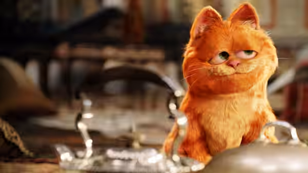 Garfield sits at a dining table, looking ahead